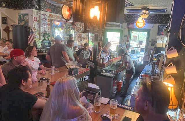 crowded pub interior with busy decor and diners watching sports at ann omalleys irish pub st augustine