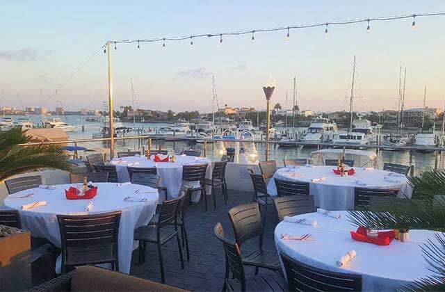 dining patio tables and chairs overlooking marina with boats at marina cantina tequila bar grill clearwater