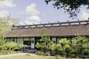 exterior of a traditional japanese building with trees at morikami museum japanese gardens delray beach