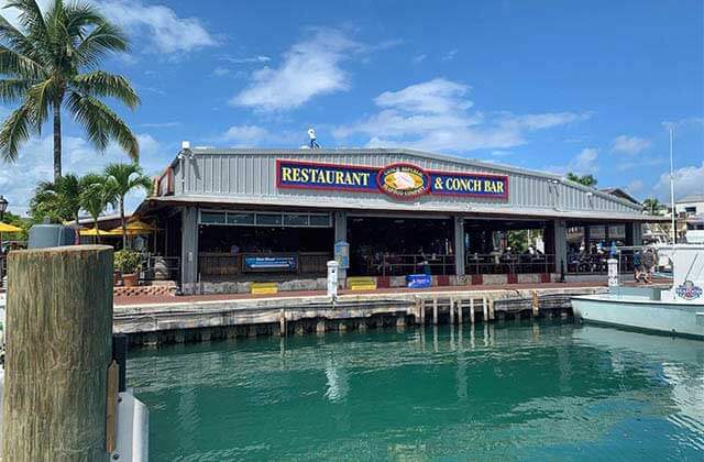 exterior view across marina with boat at conch republic seafood company key west