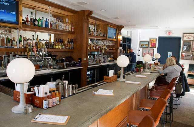 full bar with bottles and light globes at st augustine seafood company