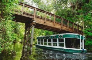 glass bottom boat exterior on river under bridge at silver springs state park ocala