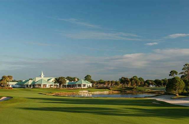 golf green with clubhouse and water hazard at pga golf club port st lucie