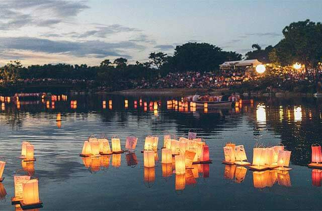 hundreds of glowing lanterns on a lake at twilight at morikami museum japanese gardens delray beach