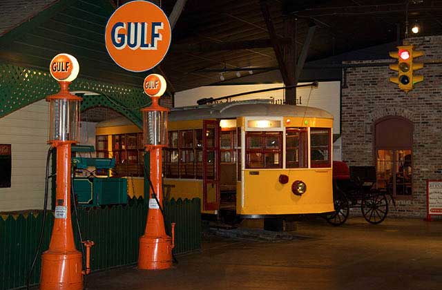 interior of museum with antique trolley and gas pumps at historic pensacola tour