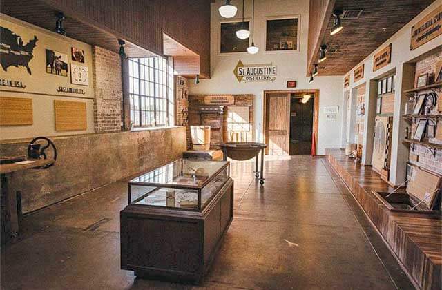 large room with display cases and museum exhibits at st augustine distillery