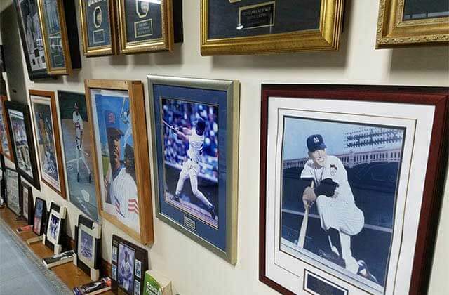 many baseball photos and memorabilia framed on a wall at tallahassee automobile museum florida