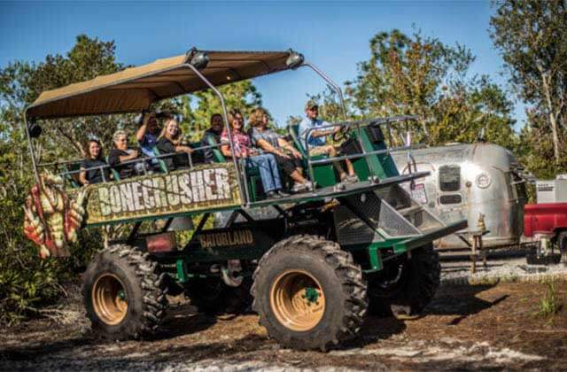 monster truck safari vehicle with bonecrusher sign at zipline stompin gator off road adventure gatorland