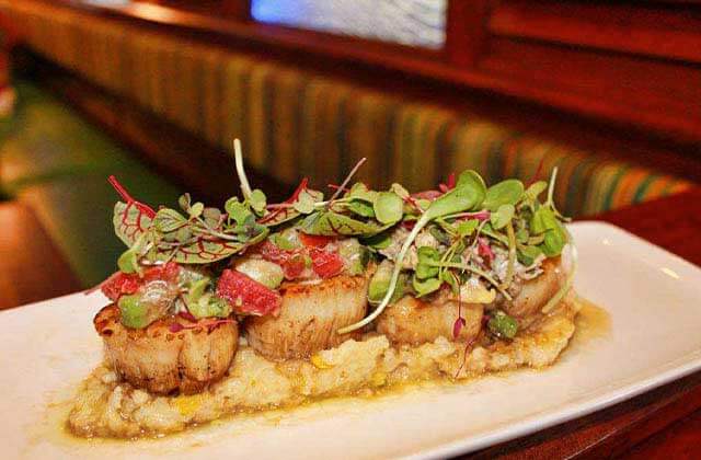 oblong plate with shrimp grits and scallops at clear sky beachside cafe clearwater