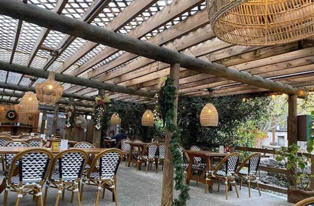 outdoor patio trellis with wicker chairs seating at taberna del caballo st augustine
