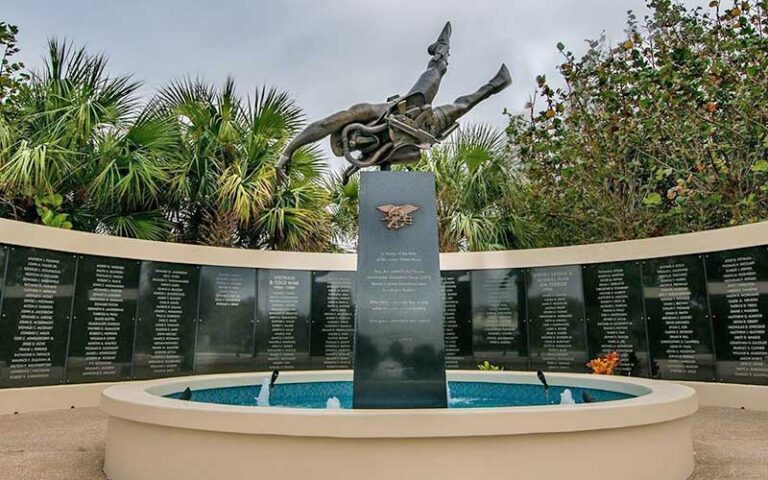 outdoor war memorial with diving seal statue at national navy udt seal museum fort pierce