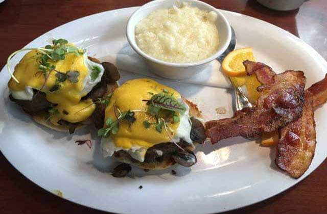 plate of eggs benedict with grits and bacon at clear sky beachside cafe clearwater