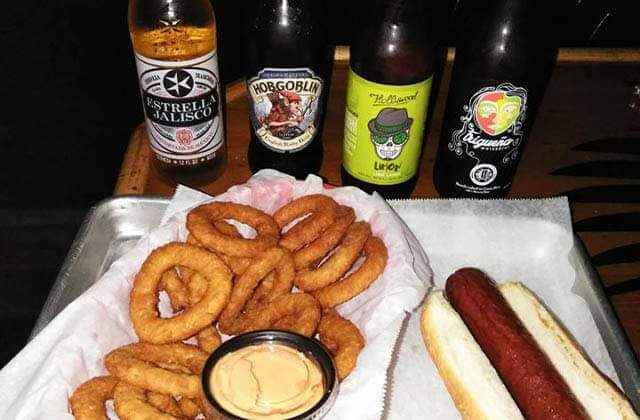 row of craft beers with hot dog and onion rings at triple b bar grill hollywood florida