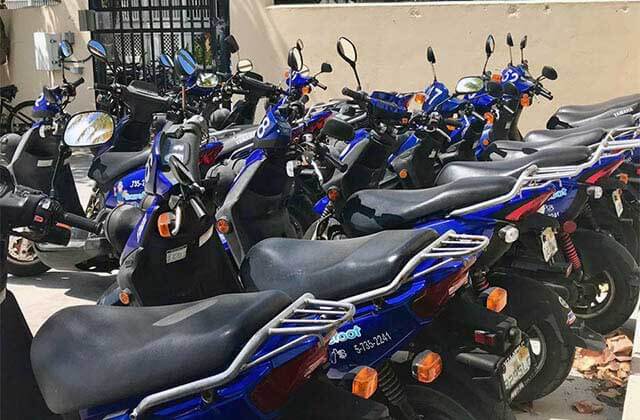 rows of blue rental scooters at barefoot billys key west