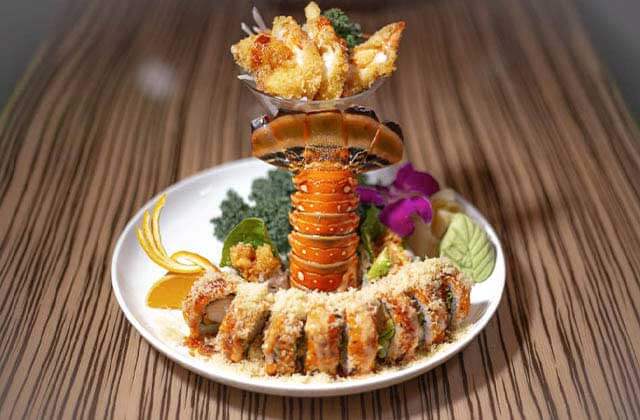 special lobster tail sushi roll with flowers and fruit garnish at sushi yama asian bistro boca raton