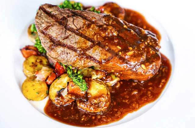 steak entree with mushrooms and red sauce at wild sea oyster bar grill ft lauderdale