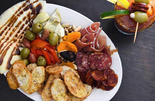 tapas platter with meats breads olives and artichoke hearts at taberna del caballo st augustine