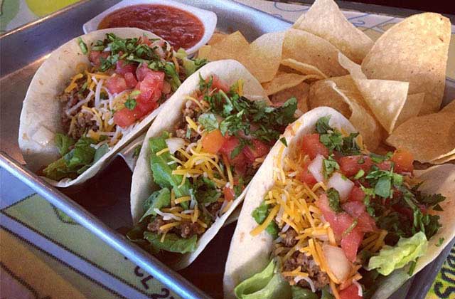 three tacos with chips and salsa in a metal tray at epic beach bar grill cocoa beach