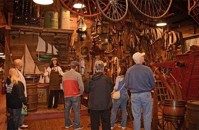 tour group listens to guide in room with antique exhibits at oldest store museum experience st augustine