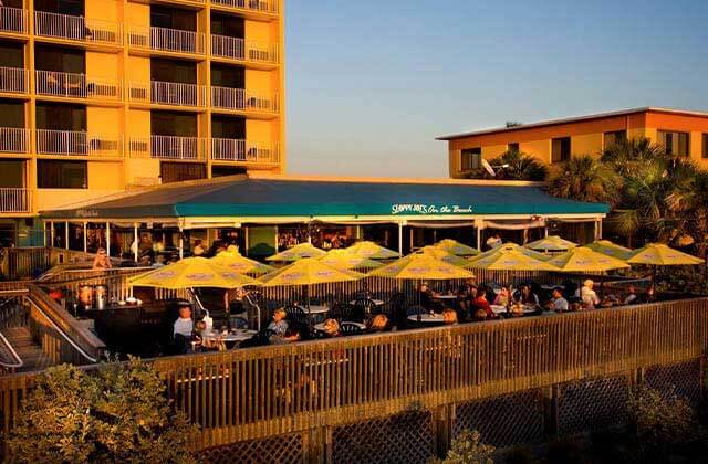 waterfront view of restaurant patio seating and dock at sunset at sloppy joes treasure island