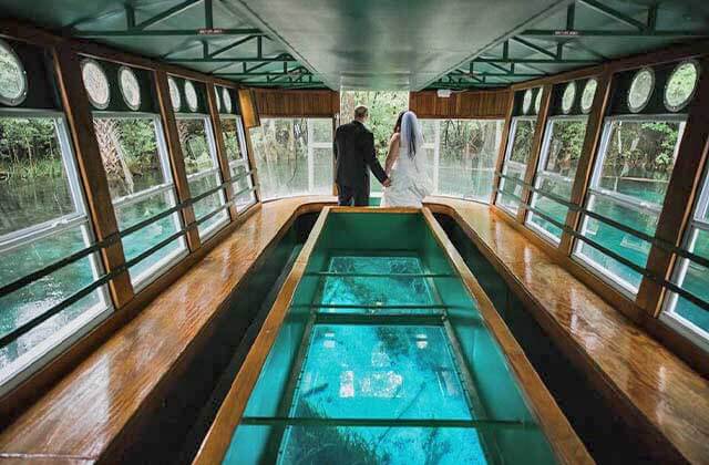 wedding couple in a glass bottom boat with view underwater of river at silver springs state park ocala