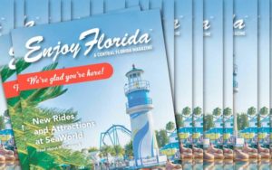 stack of enjoy florida magazine covers with seaworld lighthouse