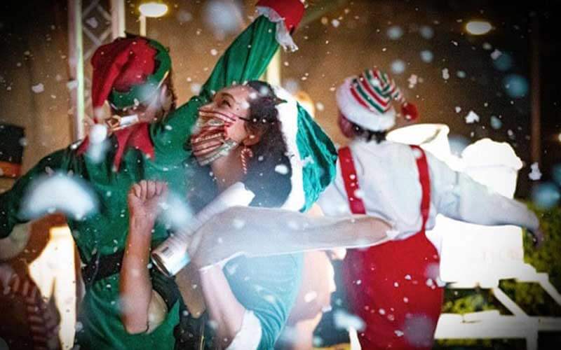 masked performers dressed as elves on stage at jolly creek