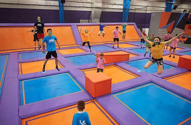 kids of different ages bounce in areas of large array of trampolines at altitude trampoline park kissimmee