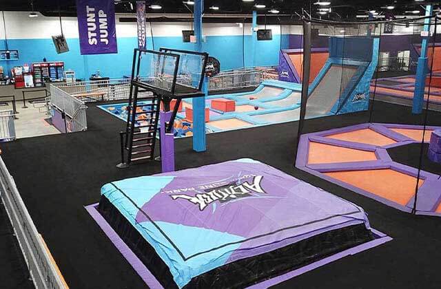 stunt jump pad with steps to platform and other trampoline areas in the background at altitude trampoline park kissimmee