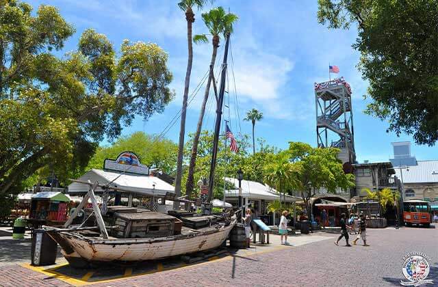 exterior parking on courtyard with old boat and tower at shipwreck museum key west
