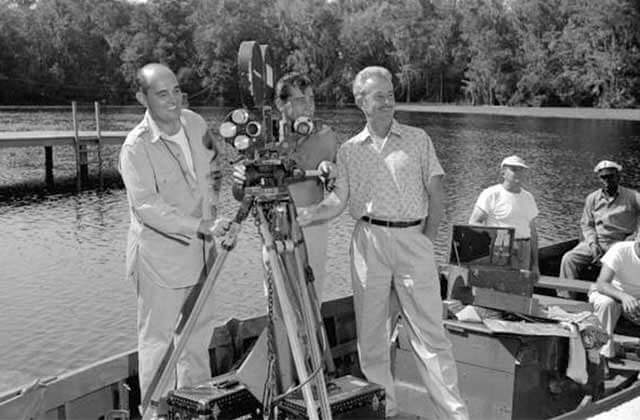 historic black and white photo with Hollywood directors with a movie camera on a boat at the lodge at wakulla springs state park florida