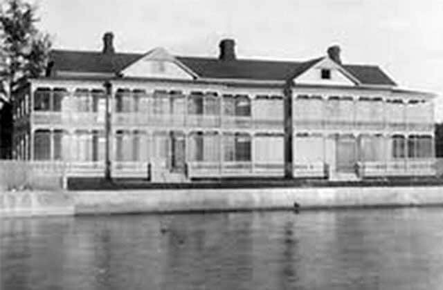 historic black and white photo of a large two story home with verandas at harry s truman little white house key west