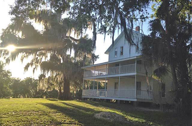 historic white house with oak trees and spanish moss at blue spring state park orange city florida