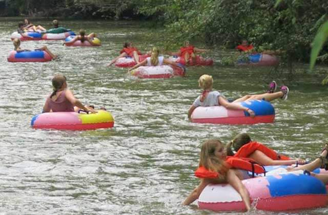 several people in inner tubes floating along a river at rainbow springs state park dunnellon florida