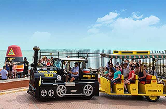 train tram parked at southernmost point marker at conch tour train key west