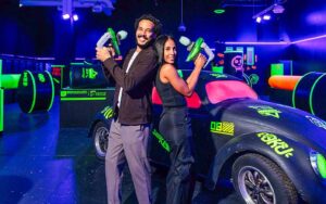 couple with laser tag guns posing at dezerland park orlando