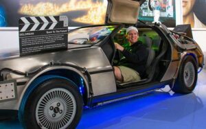 man posing in delorean exhibit at orlando auto museum dezerland park orlando