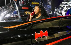 woman in batmobile with red bat phone at orlando auto museum at dezerland park