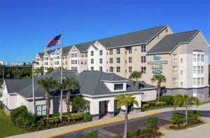 aerial view of exterior of hotel with waving flag at homewood suites by hilton orlando nearest to universal studios