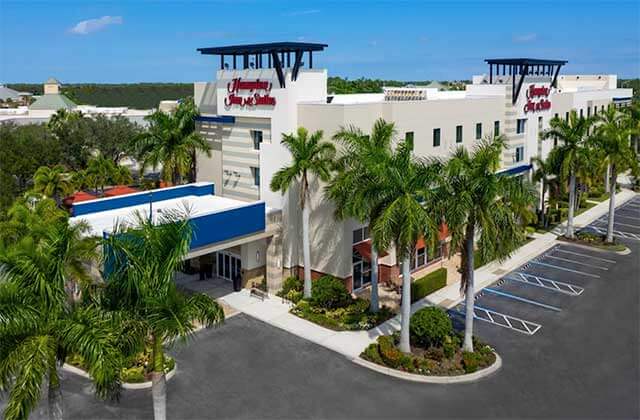 aerial view of front exterior of hotel with palm trees at hampton inn suites sarasota lakewood ranch
