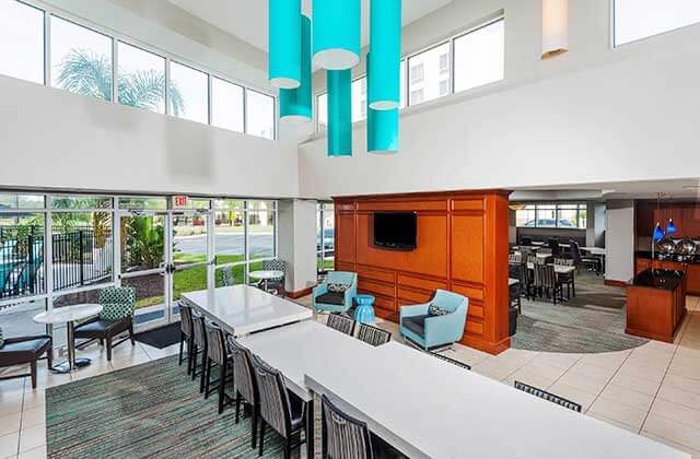 dining area with atrium and blue hanging lights at residence inn by marriott orlando airport