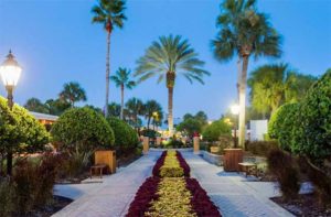 exterior at night of courtyard with trees and landscaping at wyndham orlando resort international drive