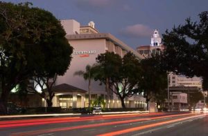 exterior of downtown hotel at night with busy road at courtyard miami coral gables