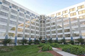 exterior of hotel building with silver and blue high rise at wyndham orlando resort and conference center celebration area