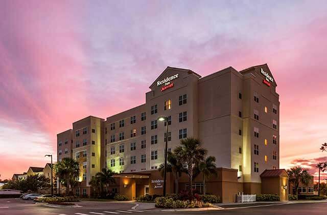 exterior of hotel with sunset sky at residence inn by marriott orlando airport