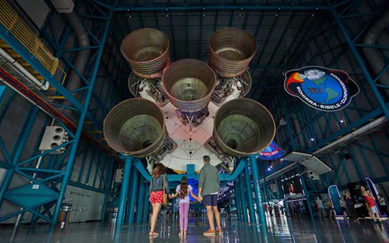 family looks up at rocket at kennedy space center visitor complex