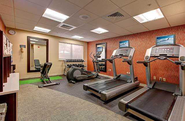 fitness room with treadmills elliptical and weights at residence inn by marriott orlando convention center