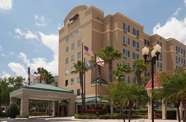 front exterior of high rise hotel with palm trees at springhill suites orlando convention center international drive area