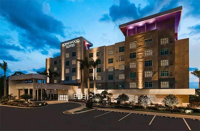 front exterior of hotel at night with purple lighting at homewood suites by hilton sarasota lakewood ranch
