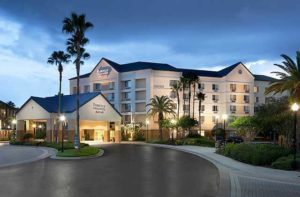 front exterior of hotel building in twilight with entrance at fairfield inn and suites orlando lake buena vista